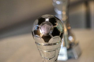smiling winner with trophy